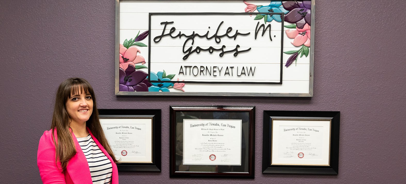 Attorney Jennifer M. Gooss in her office beside her University of Nevada, Las Vegas diplomas